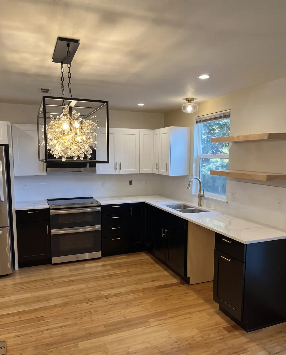 A modern kitchen remodel with custom cabinetry and a statement chandelier