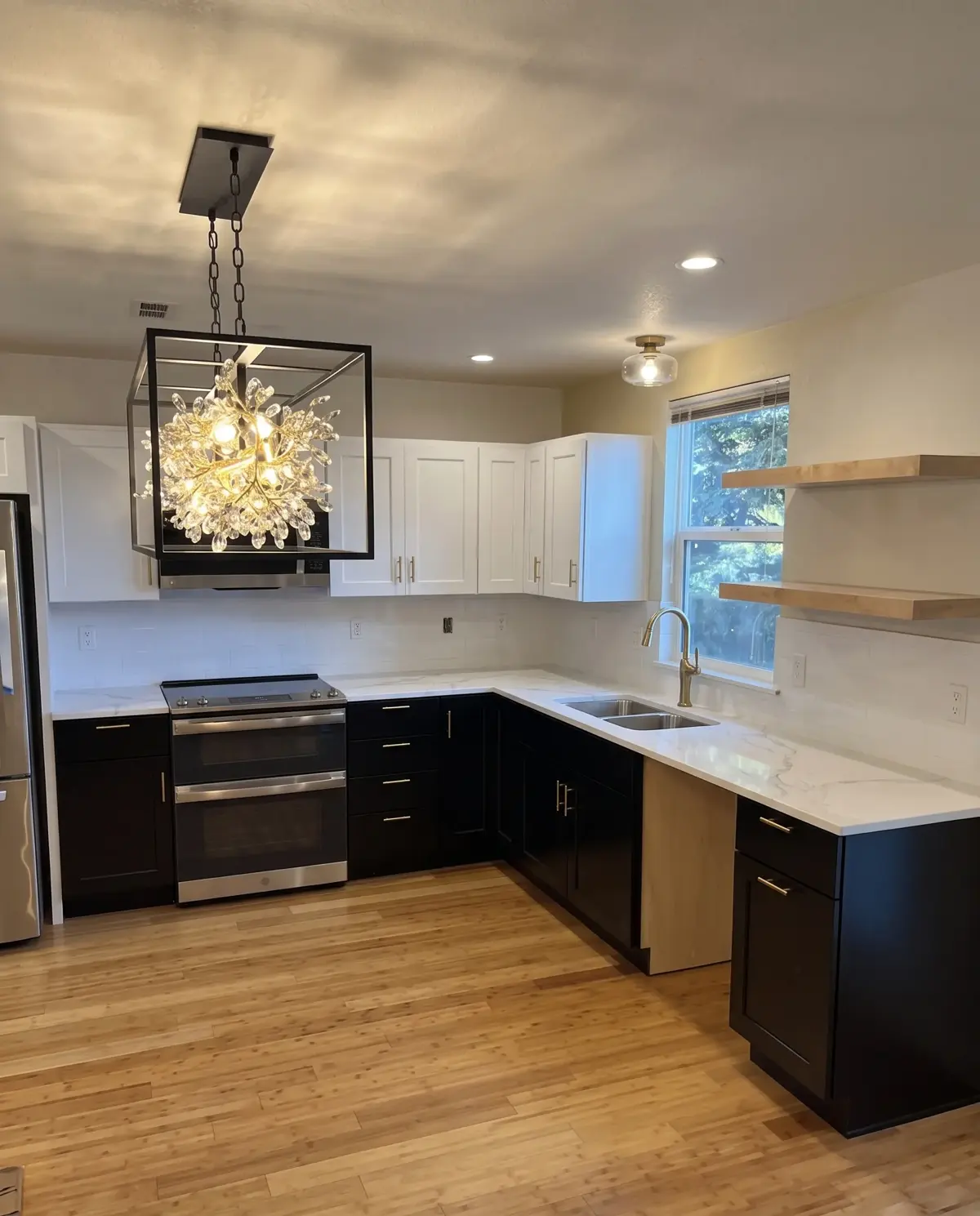 A modern kitchen remodel with custom cabinetry and a statement chandelier