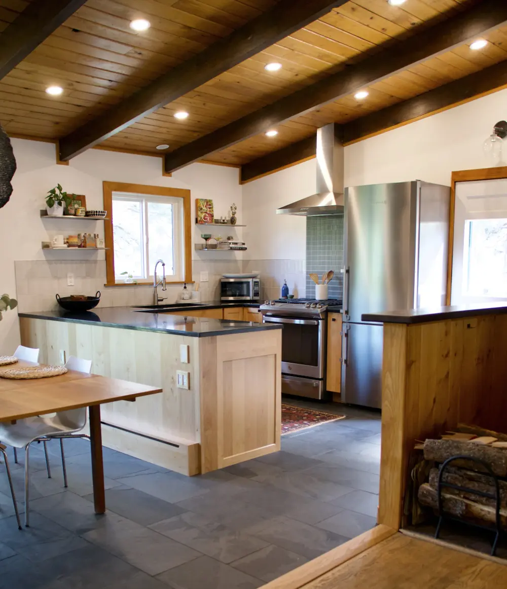 A bright Sunshine Canyon kitchen remodel with sloped ceilings, new cabinetry, tile, counters, and recessed lighting